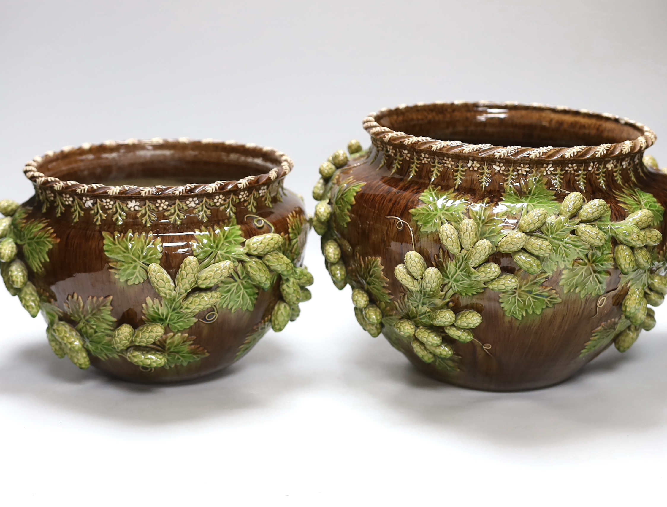 Two early 20th century Sussex Rustic Ware Rye pottery jardinières moulded with hops, each with incised marks and dated 1901 and 1903, height 21.5cm